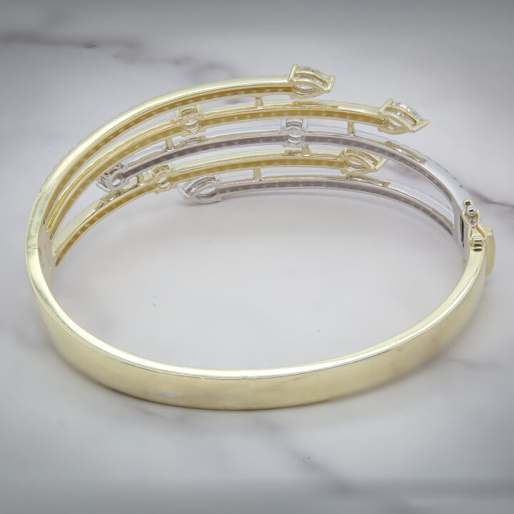 Two-tone 14k yellow and white gold multi-row diamond wraparound bangle bracelet with pear accents.