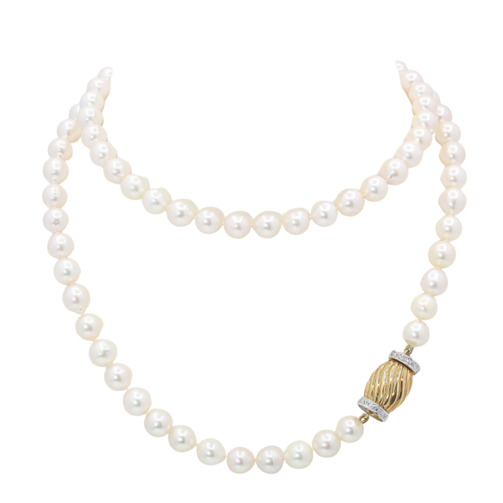 Single-strand cultured pearl necklace with fluted yellow gold and diamond barrel clasp.