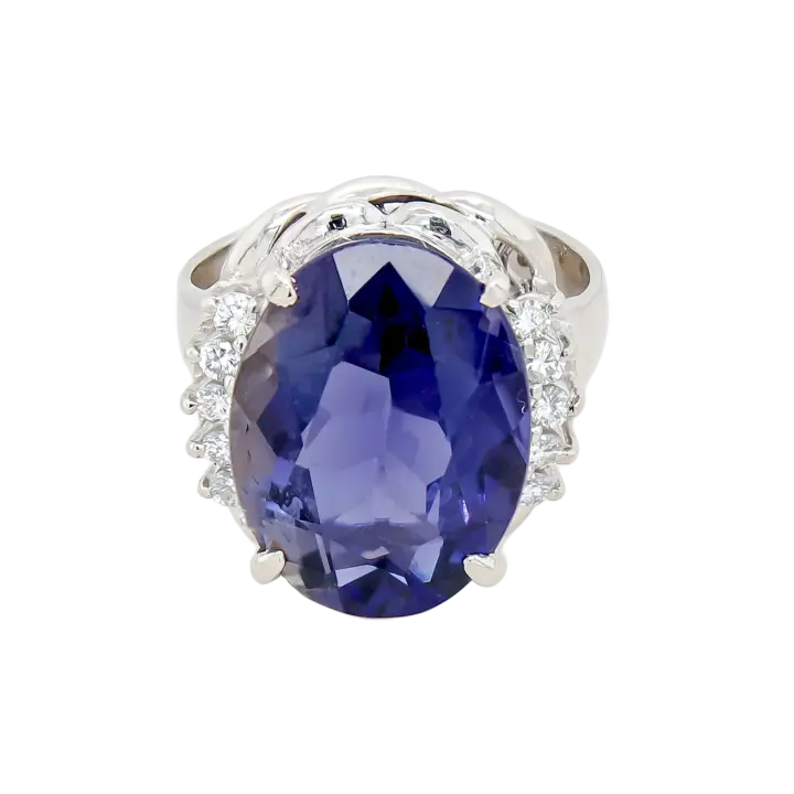 Platinum iolite cocktail ring with large oval violet-blue center and diamond side accents