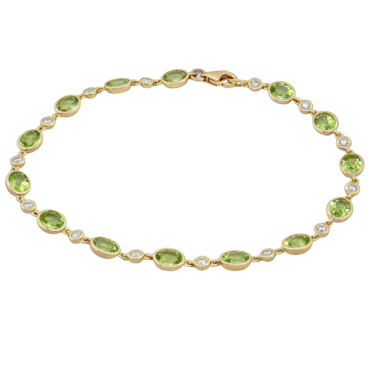 Oval peridot and round diamond bezel-set tennis bracelet in 10k yellow gold.
