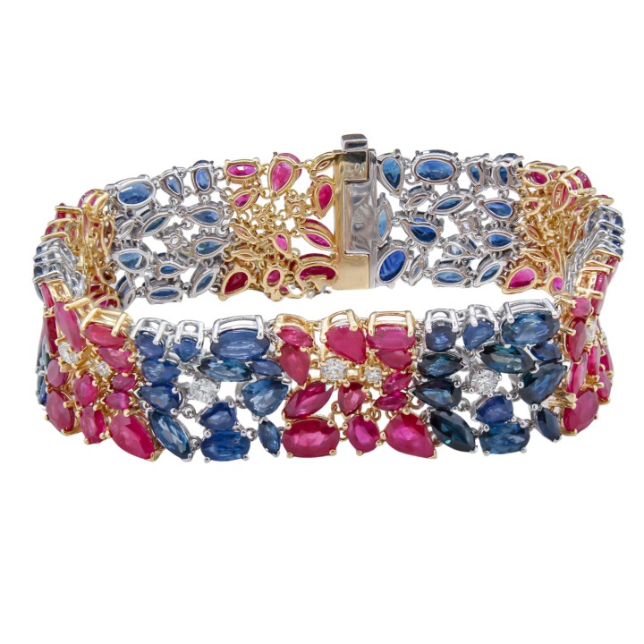 Wide two-tone 18k gold bracelet featuring pear and marquise rubies, sapphires, and diamond accents in a lush floral cluster design.