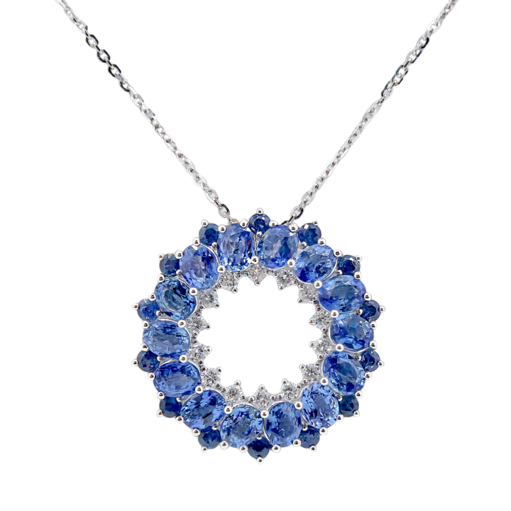 Blue sapphire and diamond open circle pendant necklace in 18k white gold.