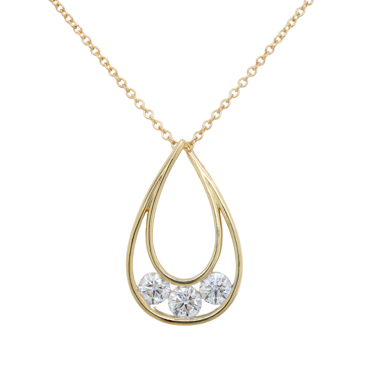 Three-stone round brilliant diamond teardrop pendant in 14k yellow gold on cable chain.