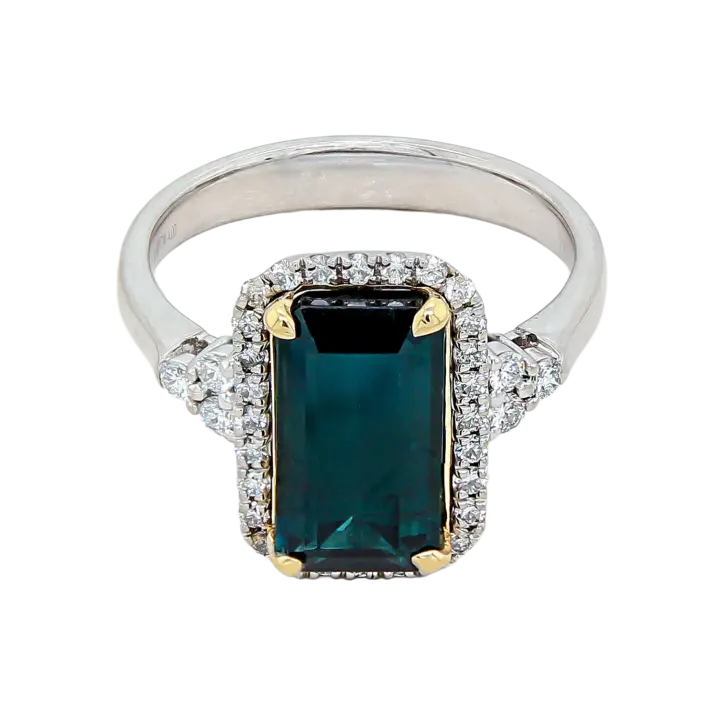 Platinum emerald-cut blue-green tourmaline ring with diamond halo and diamond cluster shoulders