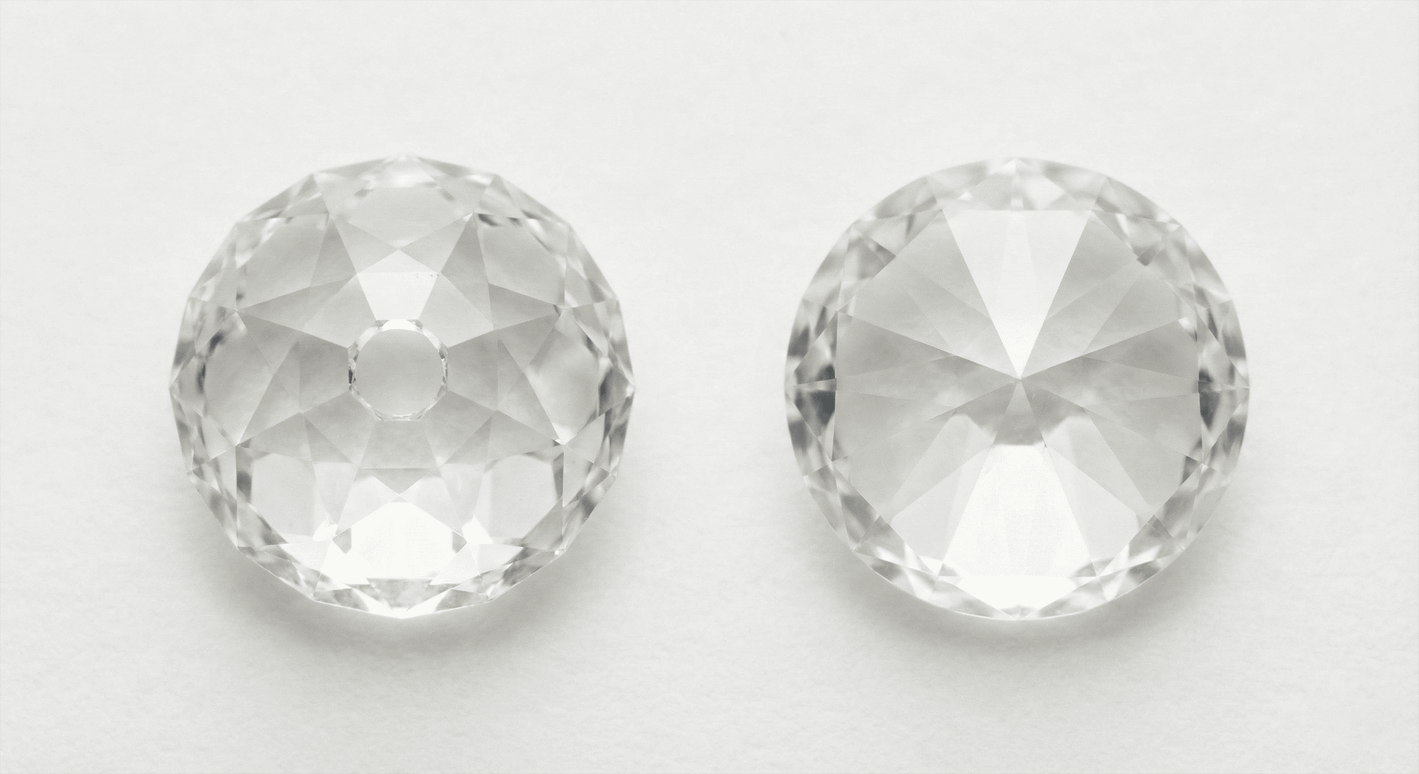 Close up comparison of loose Old European cut diamond and modern round brilliant